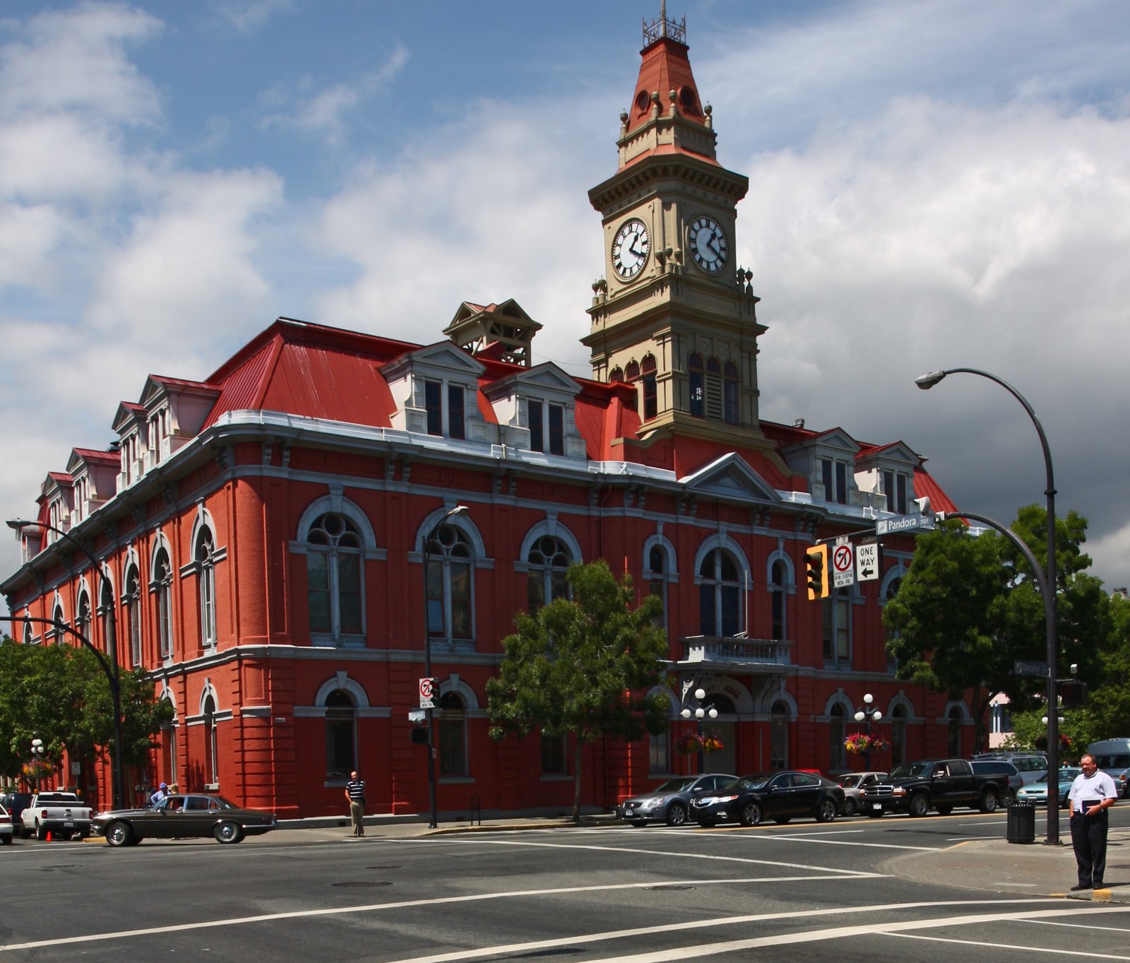 Victoria City Hall, a red-brick Second Empire-style building with a clock tower, seen from the street.